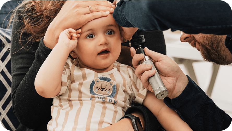 GP examining a child's ear